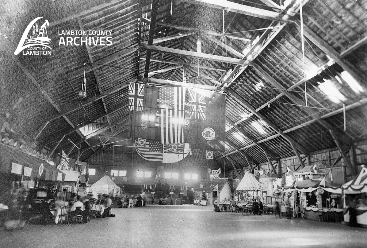 Event space lined with vendors, black and white photo
