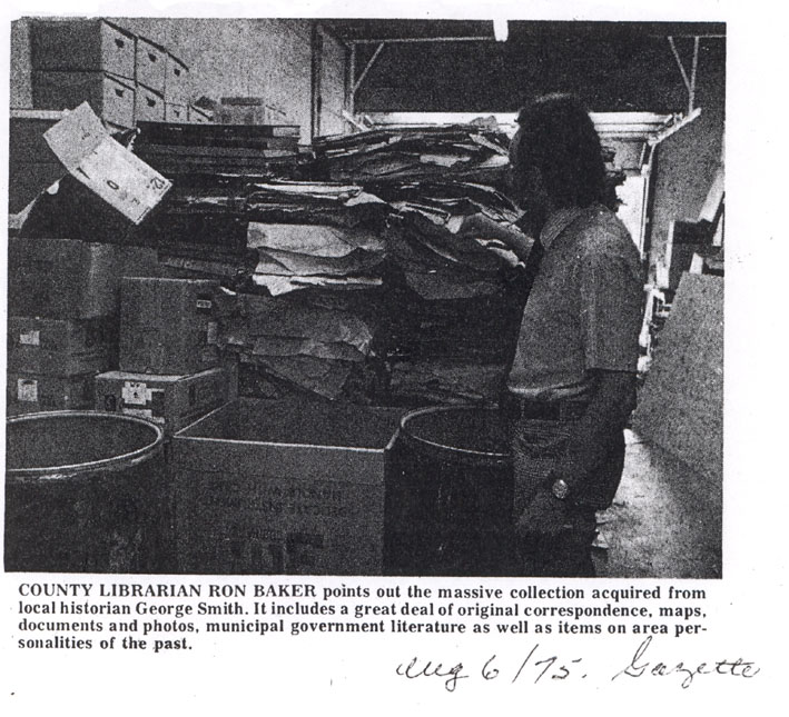 County Librarian Ron Baker points out massive collection acquired by George Smith, Sarnia Gazette,1975