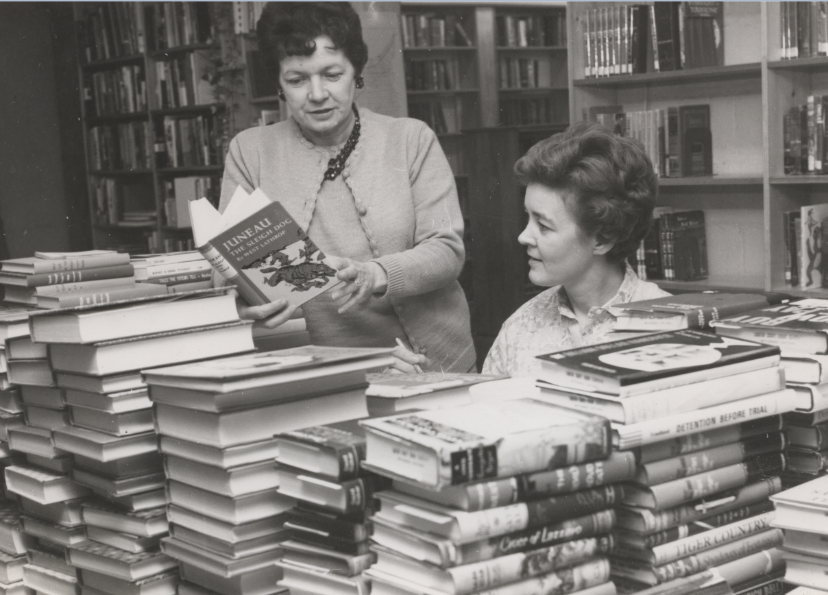 Two women looking at books.