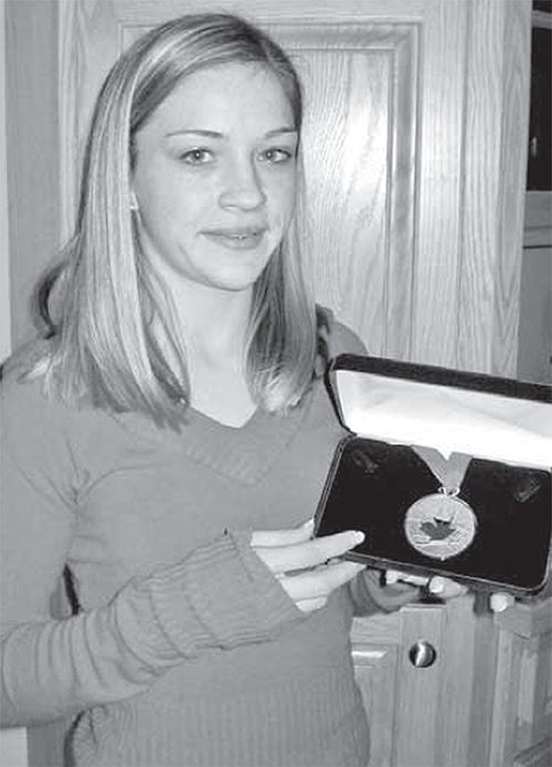 Diane Szmiett, Canadian Junior Women’s Figure Skating Champion, holding her medal.