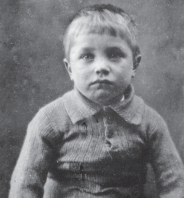 Cyril Hewitt, age 4, dressed in a knit sweater.