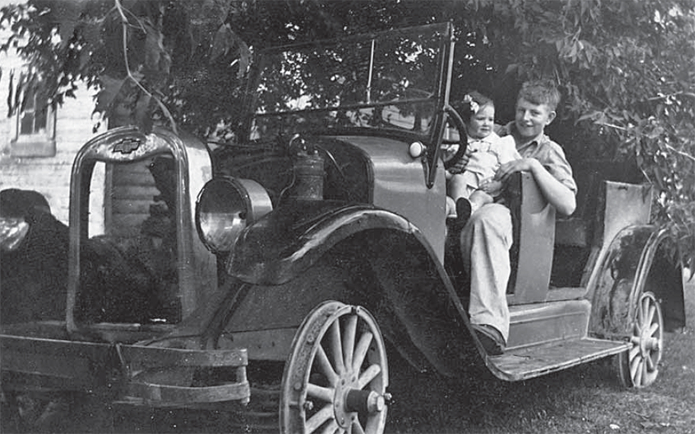 Children playing in an old car.