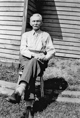 William Weedmark sitting outside on a stool.