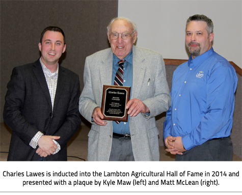 Image Caption: Charles Lawes is inducted into the Lambton Agricultural Hall of Fame in 2014 and presented with a plaque by Kyle Maw (left) and Matt McLean (right).