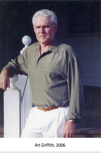 Art Griffith leaning on a stair railing. Image Caption:"Art Griffith, 2006." 