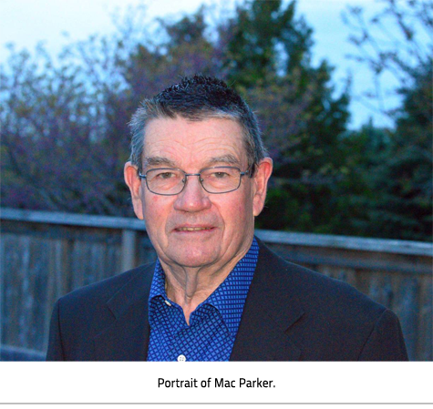 Mac Parker in a suit. Image Caption: "Portrait of Mac Parker."