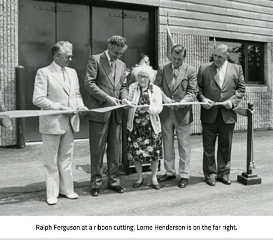 Ralph Ferguson holding a ribbon at a ribbon cutting with 3 other men and one woman. Image Caption:  Ralph Ferguson at a ribbon cutting. Lorne Henderson is on the far right.