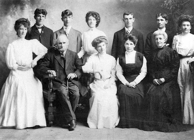 My husband’s grandfather, John, with his wife Ellen and their nine children (1911).