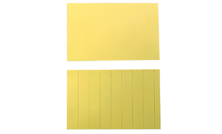 Two pieces of yellow paper. One with lines drawn on it.