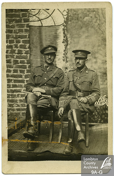 Two army men sitting.