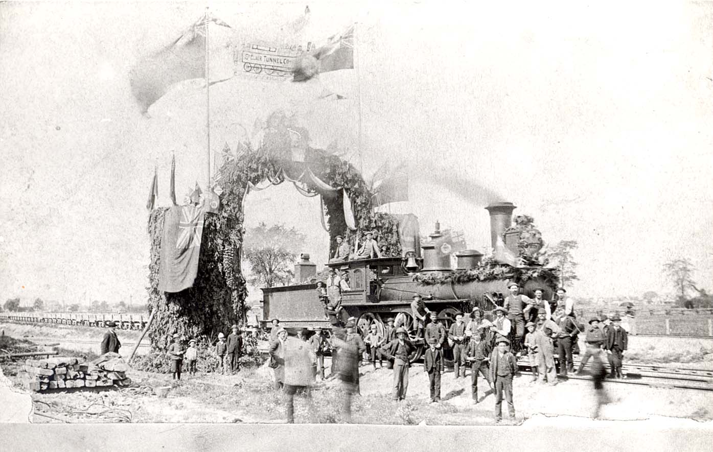 A group of men standing in front of a decorated train.