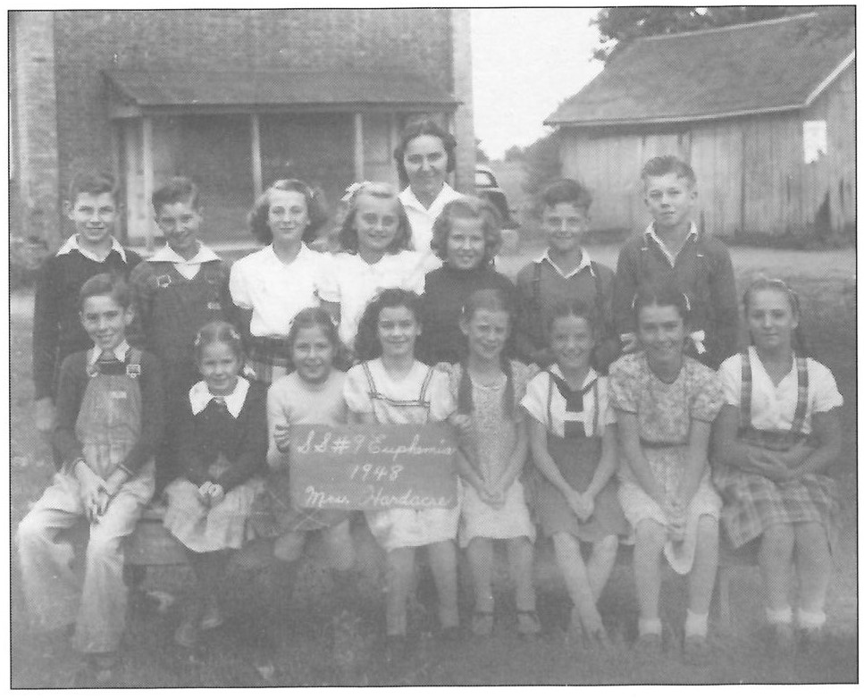 group of students in front of a school, black and white photo