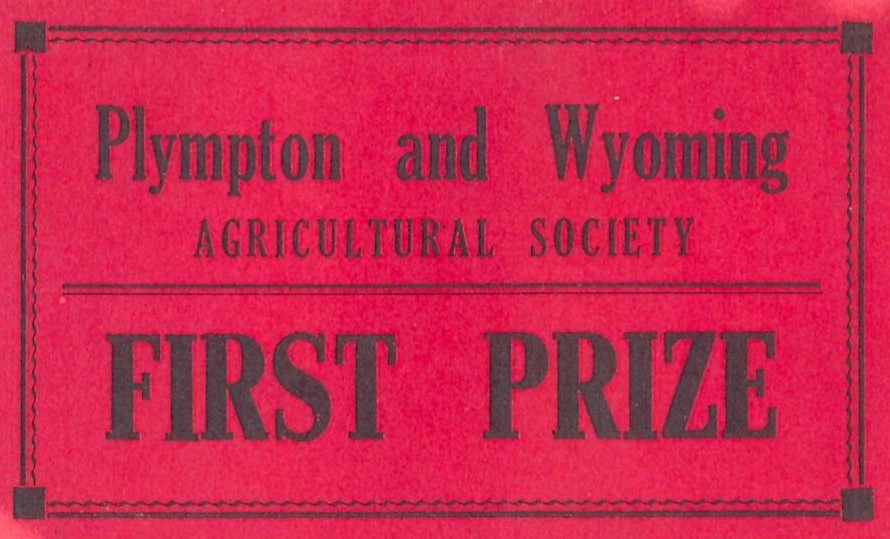 A faded red label reading Plympton and Wyoming Agricultural Society First Prize in bold black font.