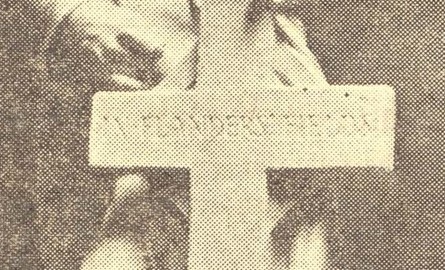 Black and white image of a soldier statue standing behind a cross, part of the Petrolia and Enniskillen Soldiers’ Memorial.