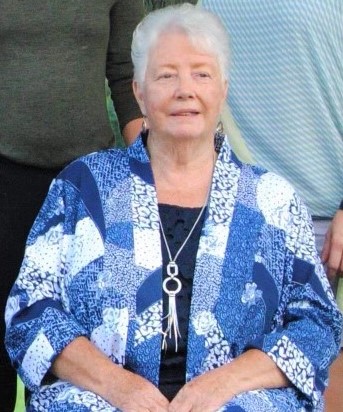 Older white woman in a blue button down shirt