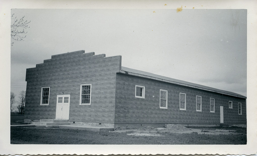 Black and white image of a long brick building.