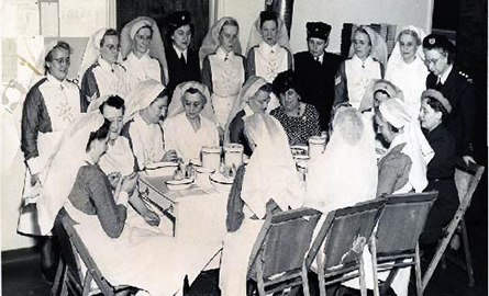 a group of nuns sitting around a table.