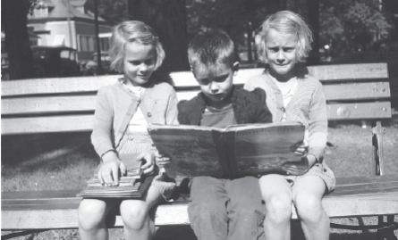 Two children sitting in front of a computer.