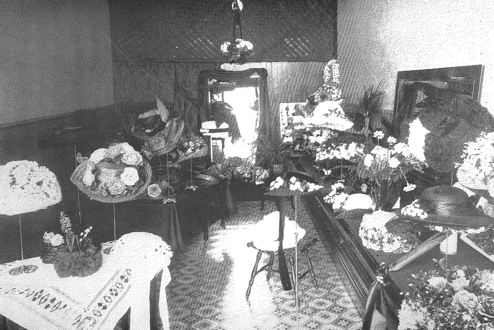 Black and wite image of hats on display stands.