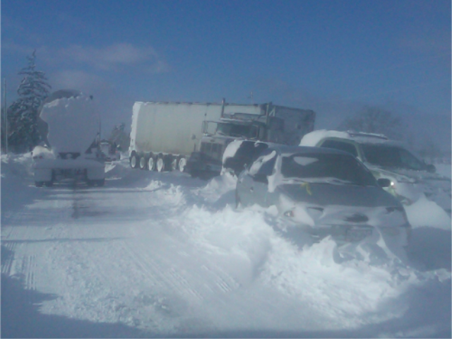 Car pile up on a highway in a snowstorm.