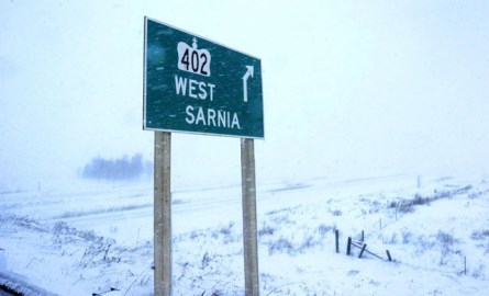 402 to Sarnia road sign in a snowstorm.