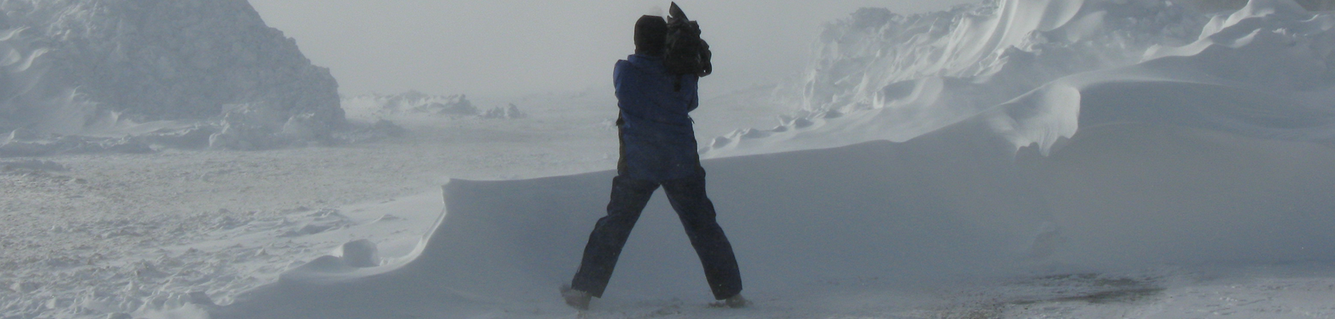 Cameraman standing in the snow.