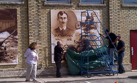 Scaffolding in front of a mural.