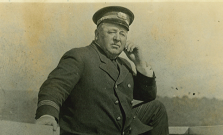 Old image of a white man posing in a sailor outfit.