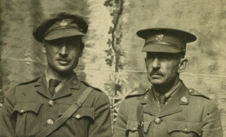 A sepia-toned photograph of two World War I officers in uniform seated side by side, taken in Steenvoorde, France, on August 24, 1916.