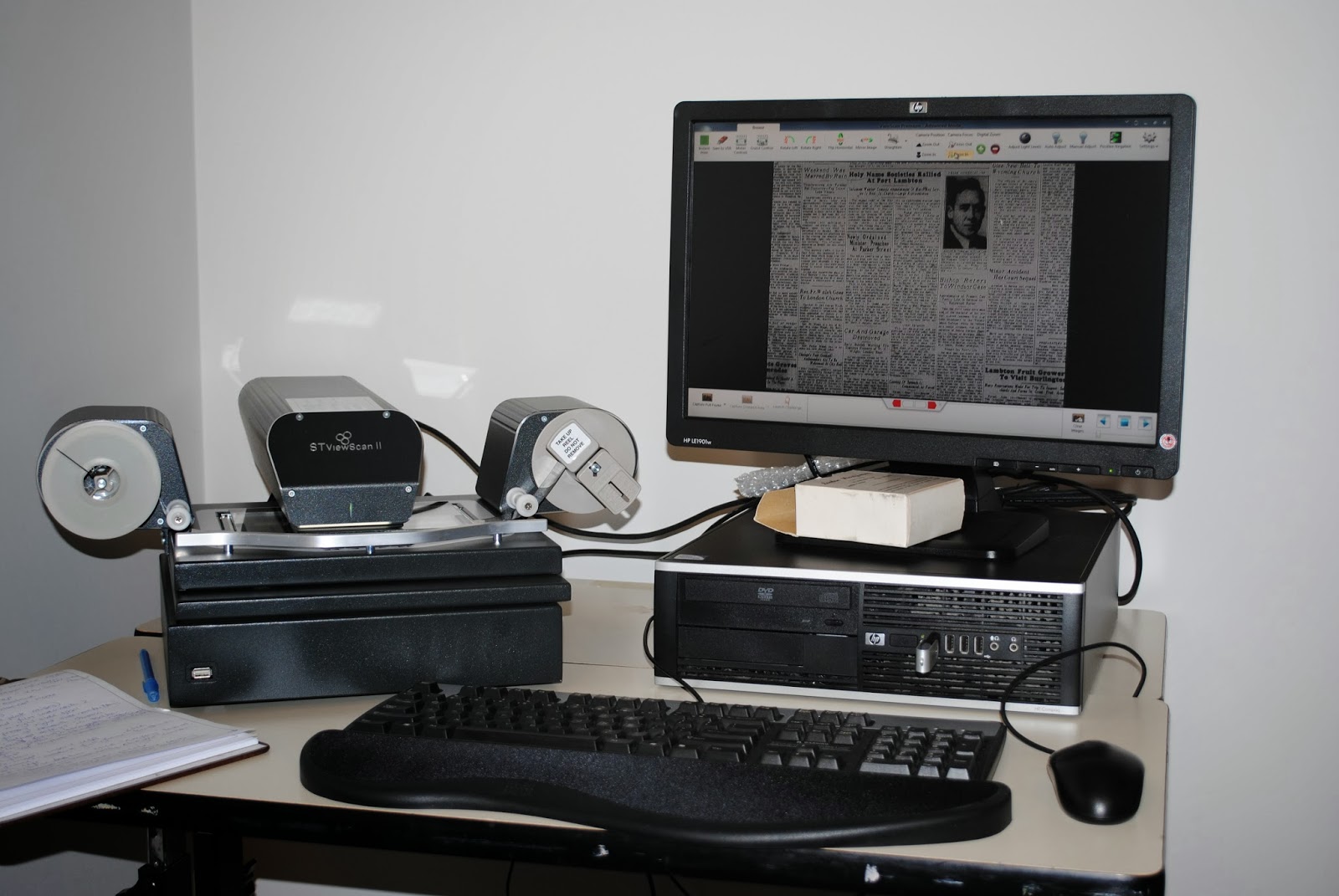 Scanner and computer on a desk.