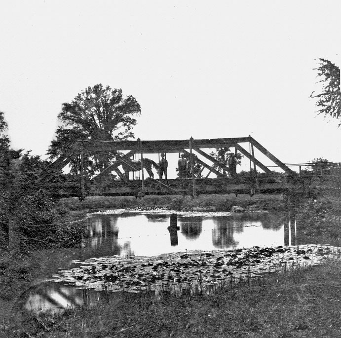 Horse and man on Bear Creek bridge.