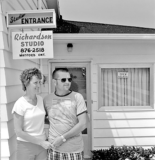 Gord and Jean Richardson in front of their studio.