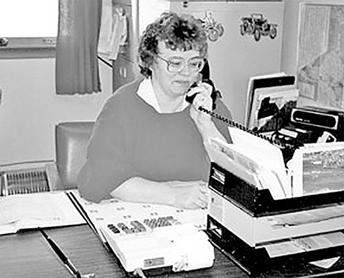Marjorie Willoughby on the phone in L. Willoughby Fuels office. 
