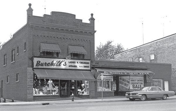 Burchill's Clothing store in a brick building with fancy parapets.