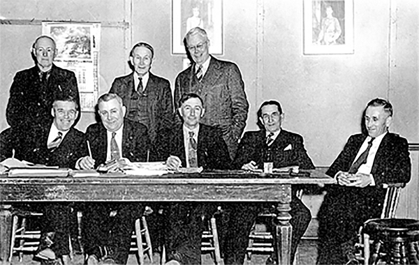 8 men standing and sitting who made up the Warwick Twp. Council, 1951.