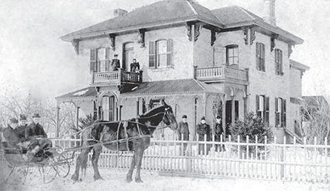 A large two story home with some typical architectural features from the 1880s.