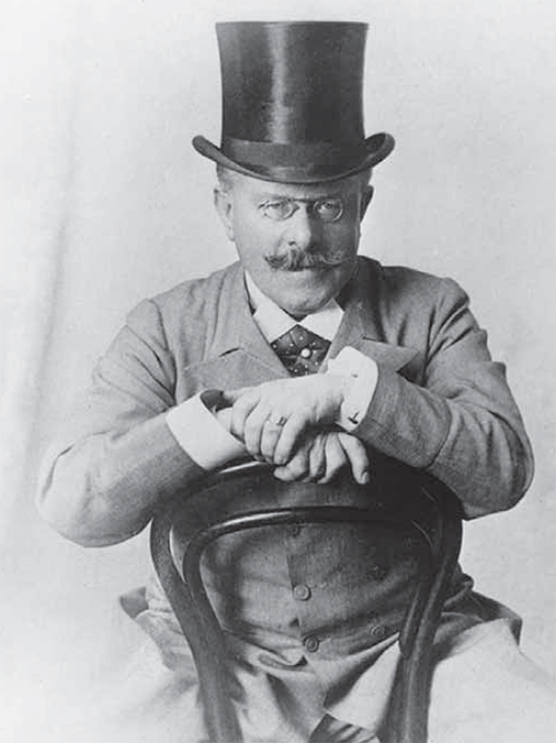 Dr. Thomas Barnardo sitting backwards on a chair.