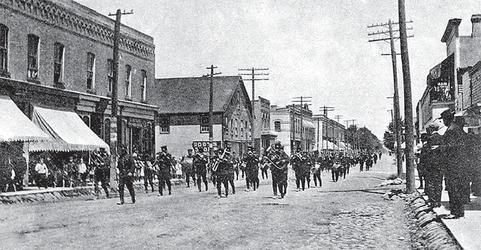 Watford boys/troops return from camp and there is a parade.