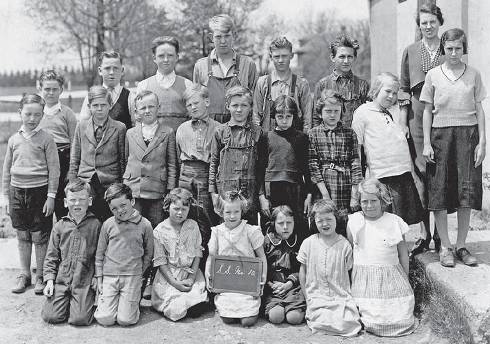 School photo, of 22 children at SS#10 school house.