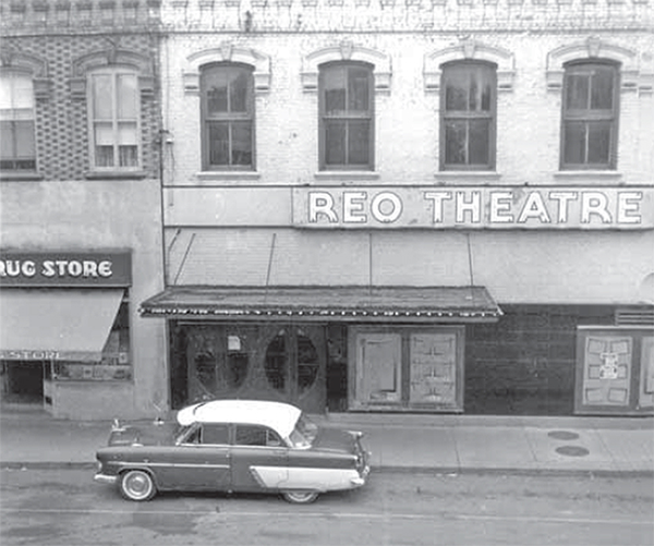 Reo Theatre building in Watford with a car parked in front of it.