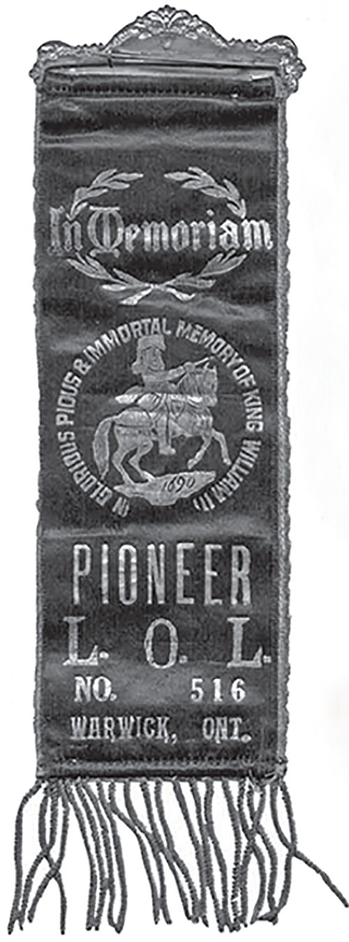 Orange Lodge Badge with tassels at the bottom.