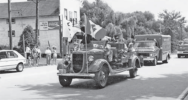 Warwick Firemen participating in parade through the Village. 