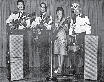 A signed photo of Roger Quick and the Rainbows on stage.