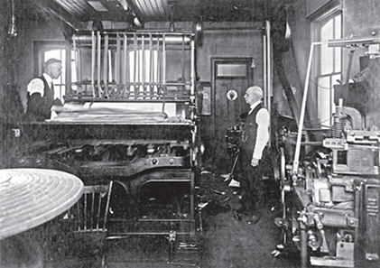 William C Alyesworth printing the newspaper on a large press. 