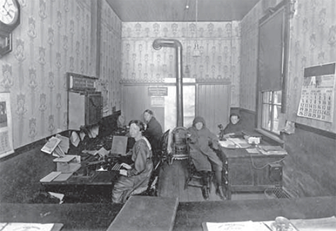 Four people working in the Telegraph office.