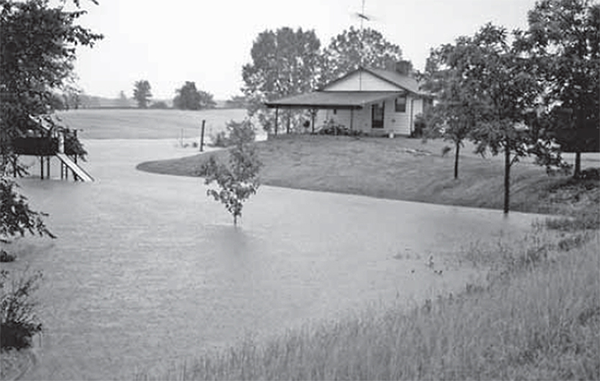 House on a hill with Flash flood water around hill.