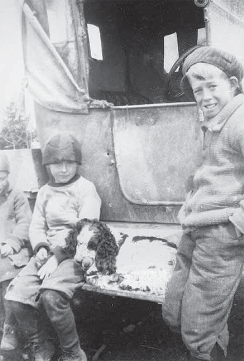 Ed and John Dolan sitting on a vehicle.