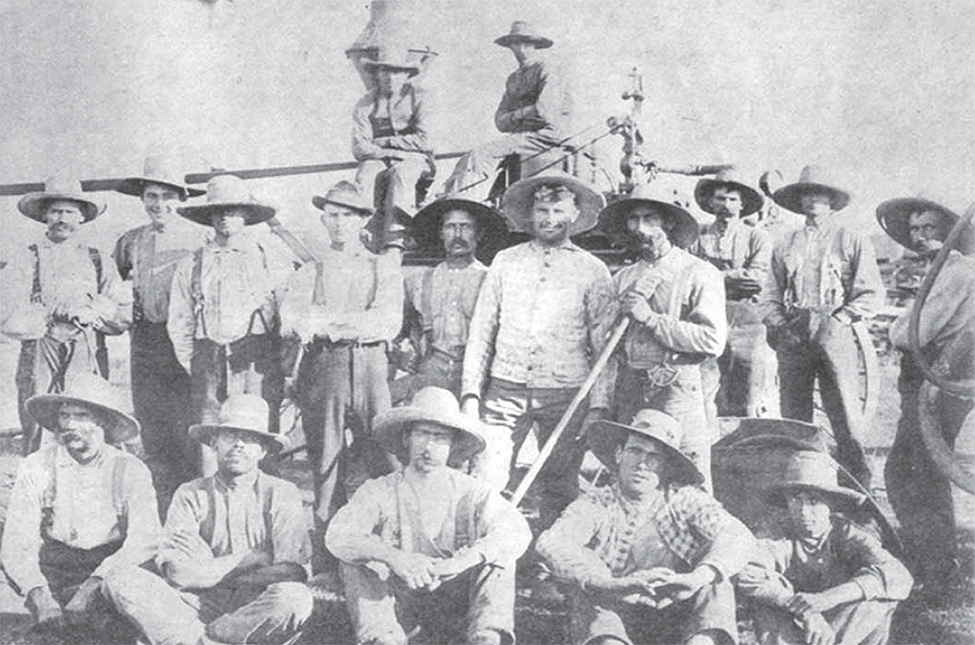 6th Line Group threshing gang, wearing wide brimmed hats.