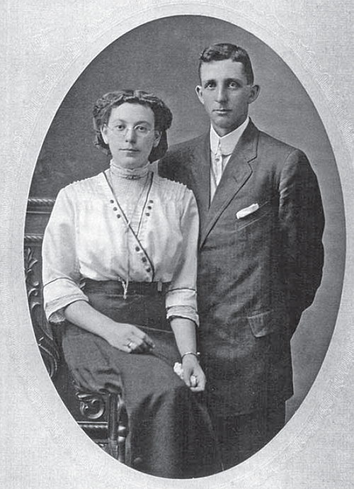 Mary Reid Shaver sits beside her standing husband Orville Ramsay.