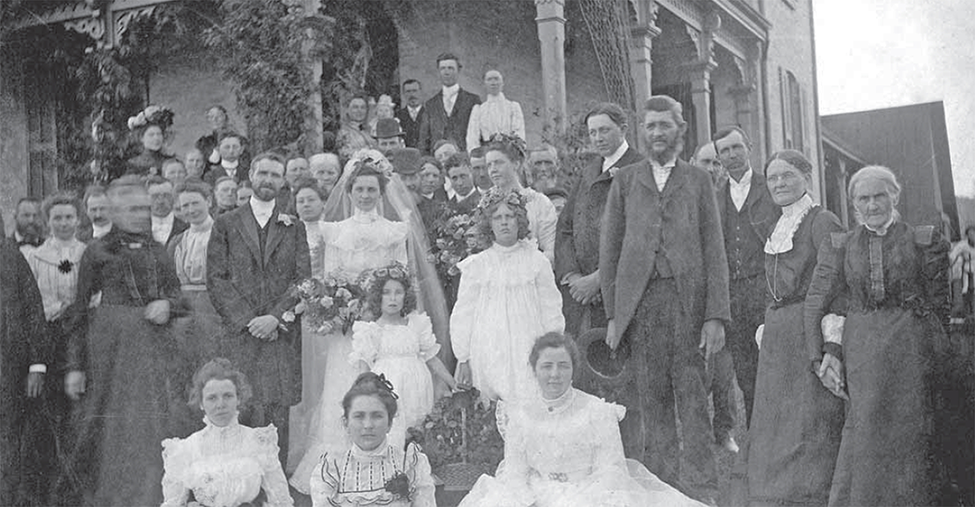 Large group with a bride and groom in the front.